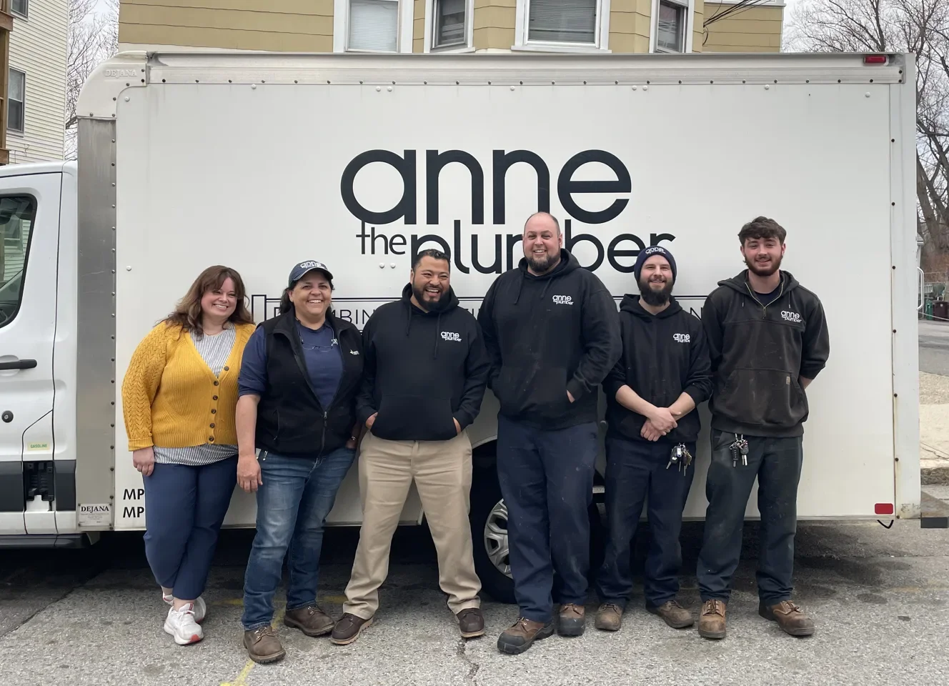 The Anne the Plumber team in front of their branded service truck