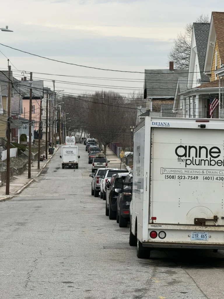 Anne the Plumber branded trucks on a Woonsocket residential street